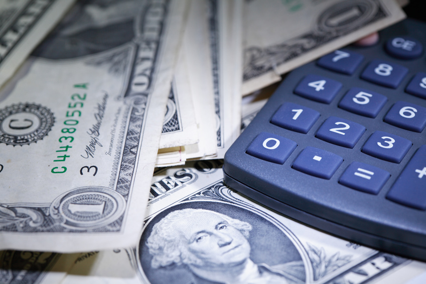 Financial background. Closeup of one dollar notes near calculator